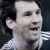 Pixelated close-up of a person with short dark hair wearing a light-colored patterned shirt against a dark background.