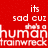 Red background with white pixelated text reading 'its sad cuz its a human trainwreck' in four lines, no visible characters or objects.