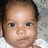 A child in a white garment against a patterned background with subtle expression changes across frames.
