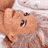 A baby in a white outfit lies on a white surface, with visible text 'CoolBuddy.com' in the lower-left corner.
