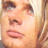 A static close-up of a person's face showing eyes, nose, mouth, and hair with warm skin tones.