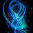 Animated blue and cyan swirling lines form a dynamic, abstract pattern against a dark background with scattered red and green pixels.