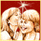 Two blonde women in white tops share a close embrace against a red background with a starburst effect, one woman's head tilted toward the other.