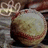 A pixelated softball rests on a textured surface with a hand holding it, accompanied by cyan text on black backgrounds.