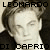 Pixelated image of a person with light hair and dark clothing, text above and below the head.