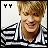 Pixelated static image of a person with light brown hair and a white shirt, with black text 'YY' in the top-left corner.
