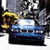 Pixelated image of a blue car with a yellow figure on the left side, set against a dark background with light and dark gray tones.