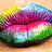 Four distinct rainbow-colored pixelated images arranged in a : lips, swirl, sliced fruit, and a bowl of multicolored contents