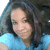 A pixelated close-up of a person with dark hair wearing a light blue top, captured in a static image.