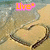 Beach scene with heart drawn in sand, water washing over it; three text overlays reading Live, Love, Laugh.
