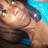 Pixelated close-up of a character with light brown skin, dark hair, and closed eyes against a blue background.
