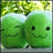 Two green cartoon characters with closed eyes and smiling mouths stand side-by-side under a leafy tree, set against a light blue sky background.