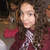 A person with long curly brown hair wearing a maroon top and silver necklace, shown in three where the head position shifts slightly left to right