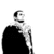 Pixelated grayscale icon of a figure in a dark cloak with a light-colored collar, standing against a white background.