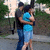 Two people embrace outdoors; the person in blue shorts shifts position slightly across frames.