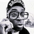Pixelated grayscale image of a person wearing glasses and a checkered headband, with one hand raised near the face.