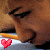 Pixelated static image of a person's face with closed eyes and a red heart icon in the bottom left corner.