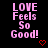 Pixelated pink text reads "LOVE Feels So Good!" on black background with red heart symbol below.