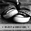 Black-and-white image of feet in jeans and sneakers with text "IN JUST A SIMPLE GIRL" below, repeated in a
