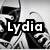 Black and white pixelated image of a character with flowing hair and a dark top, overlaid with the text 'Lydia' in bold white letters.