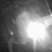 A grayscale animated icon shows a bright light source expanding and dimming , with faint background shapes visible