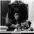 Black-and-white film stills of a person holding a child appear above text reading 'say hello to my little friend' with red lettering on the word 'friend'.