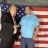 Two pixelated figures stand side-by-side against a striped background with red, white, and blue tones.