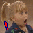 A pixelated image of a girl with blonde hair in a high ponytail, wearing a dark blue jacket with green and red details, her mouth open in surprise, with a red or blue exclamation mark in the corner.