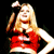 Animated contact sheet showing two frames of a blonde woman in red cheerleading outfit with large pink bow, performing different poses against black background.
