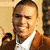Brown background with repeated text 'Chris Brown' and 'Brandie', heart symbols, a photo of a smiling man in brown jacket over white shirt.