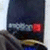 A dark blue rectangular shape with a red square and gray horizontal bar, partially obscured by brown and gold elements.