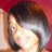 A person with short dark hair and light skin smiles against a red background, shown in four -aligned