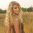 Pixelated image of a person with long blonde hair in a field, next to text about Taylor Swift's song "tear drops on my guitar" on a pink background.