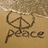 A beach scene with a peace symbol drawn in sand, waves washing over it, and the word 'peace' written below.