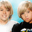 Two people with light brown hair appear in a pixelated image; one wears white, the other black clothing. Text reads "just call me..." and "Mrs. Sprouse." on blue backgrounds.