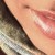 Pixelated image showing diagonal gradient of peach and brown tones with scattered light and dark patches.