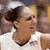 A basketball player in a white jersey with 'UConn' and number 3 on the back, wearing a headband and holding a ball.