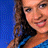 Pixelated static image of a person with long brown hair wearing a dark top against a blue background, rendered in low-resolution 48x48 pixels with visible dithering and color blending.