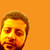 Pixelated portrait of a person with short brown hair against an orange background, showing facial features in warm tones.
