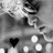 Black-and-white animated icon shows a character with large eyes and a bow, surrounded by white dots and a black heart symbol.