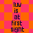 Pixelated text 'lUV is at first sight' repeated on a checkered background with alternating orange and pink squares.
