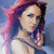 A pixelated image of a person with pink hair wearing a dark crop top and green skirt, holding an object in both hands.