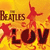 Yellow-orange background with red starbursts and silhouettes of figures dancing, featuring 'The Beatles' text above large 'LOV' letters.