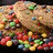 A static image shows six circular light brown icons with dark brown symbols on a white background, alongside a separate image of cookies and colorful candies.