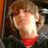 Pixelated image of a person with light brown hair wearing a red shirt and dark jacket, next to red text reading "Nuff Said :)]" on black background.