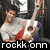 Pixelated image of two people with one holding a white guitar, text 'roekkonn' at bottom.