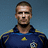 Pixelated portrait of a person in a dark blue sports jersey with yellow accents and a yellow star emblem on the chest, against a gradient blue background.