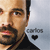 Pixelated close-up of a person with light skin tone, dark eyebrows, and a dark beard wearing a black shirt, with partial text and a heart symbol visible on the right side.