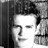 Black-and-white pixelated static icon of a person's face with dark hair, visible in grayscale tones on a transparent background.