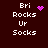 Pixelated text 'Bri Rocks Ur Socks' with pink heart and starburst animations on dark brown background.